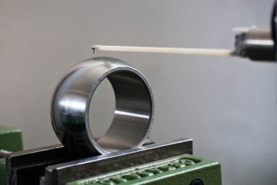 A close-up of a metal ring being measured.