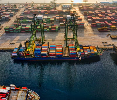 A docked blue and red cargo ship.