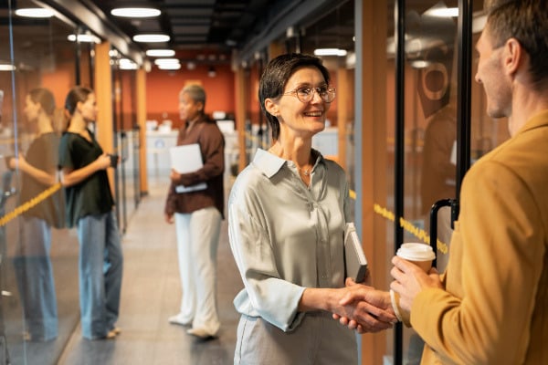 businessman and business woman shaking hand_body-1_How Cultural Differences Influence Quality Perceptions Across Markets