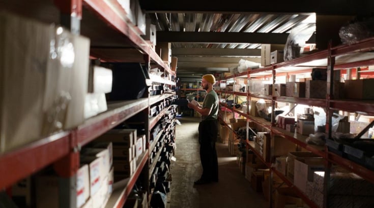 A man looking at packages in a warehouse
