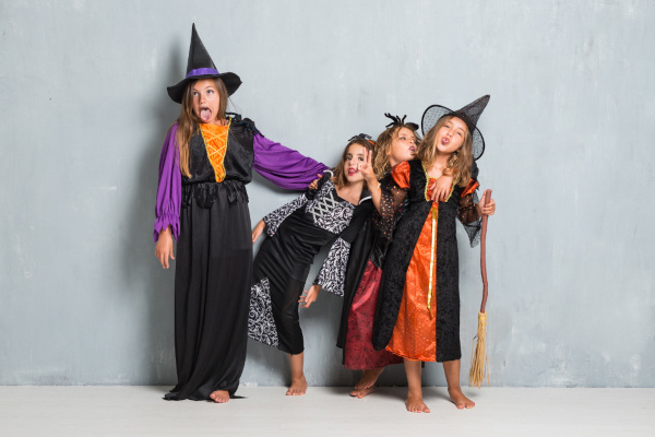 Four kid dress up in different costumes for Halloween