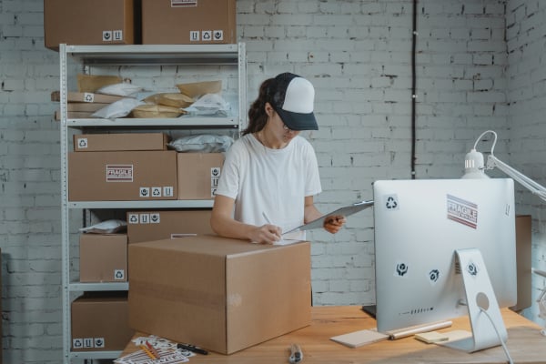 Woman performing a pre-shipping inspection to elevate product quality and the market reputation of her business.