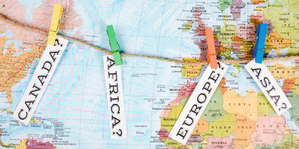 Elevated view of different continent names tag with clothes peg on map