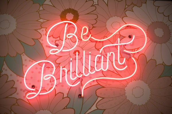 a neon “be brilliant” sign for small home décor businesses