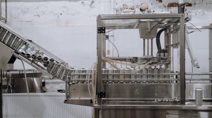 aluminum cans passing through the assembly line